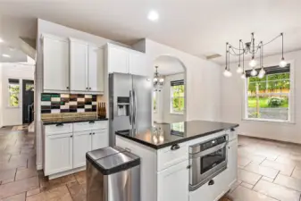Looking across the kitchen back toward entry and the kitchen dining area.