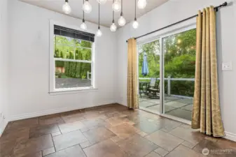 Plenty of space for a 4-6 person dining area. Step out the sliding doors to the private patio and new deck. You can hear the creek in the protected wetland behind the house.