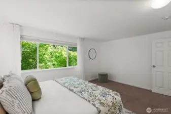 The upstairs bedroom includes an air conditioner insert, keeping the space cool and comfortable during warm summer nights.