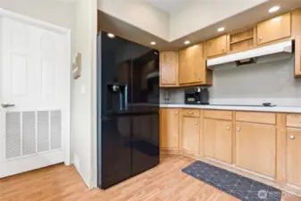 Range and fridge placement with door to the laundry/mud room.