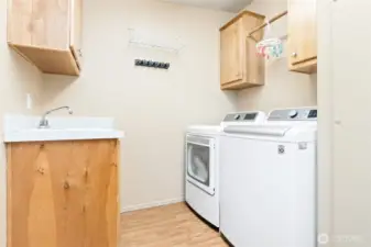 Very functional laundry room/mud room with a door to access the backyard.