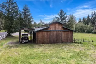 Backside of the barn with covered RV/boat parking.