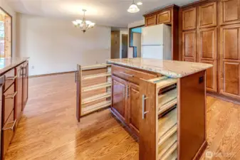 Check out the generous spice racks and pull out drawers in this island cabinet.