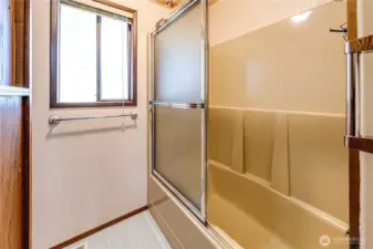 Hall bath with full bathtub and shower.