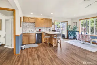 The kitchenette features a sink & mini fridge as well as bar seating.