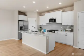 A closer look at the kitchen. The center island is large enought to seat four or five comfortably.