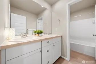 Upstairs hall bath with a door to the toilet and shower.
