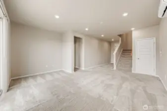 Basement level suite with 9' ceilings. This is the family room and desk area next to the stairway. A closet door to the right of the stairs.