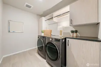 Laundry room with entensive cabinetry.