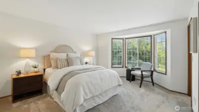The roomy primary suite offers a bay window