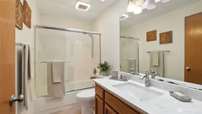 The upstairs hall bath also features a quartz counter