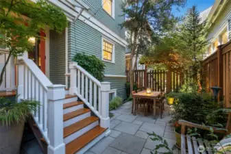 The covered back porch is just off the kitchen and is the perfect place for a grill, great for outdoor entertaining.