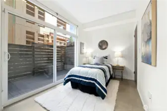 Downstairs bedroom with adjacent 3/4 bath and deck.