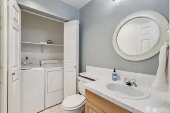half bath with full sized washer and dryer