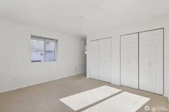 The primary bedroom is spacious with double closets