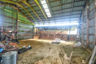 Large barn with separate sides for keeping livestock apart.
