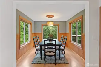You'll love the formal dining room ~ every guest has a view of the trees. All the windows and high ceilings make this home so light and bright.