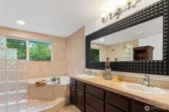 The large primary bathroom is spa-like. It features a jetted soaking tub and dual vanity ~ there is also a dedicated tankless water heater.