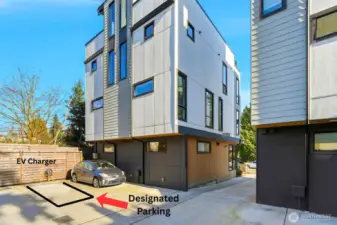 Exterior rear view of the modern townhome with designated parking space and EV charging