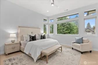 Serene and light-filled, the primary suite feels like a private retreat, with soaring ceilings, expansive windows, and an atmosphere of effortless calm.