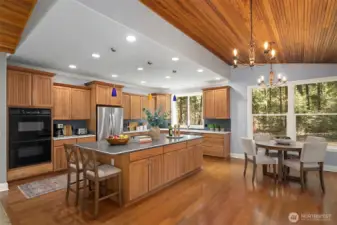 Virtually staged open concept kitchen, dining area with sparking Brazilian hardwoods and vaulted ceilings