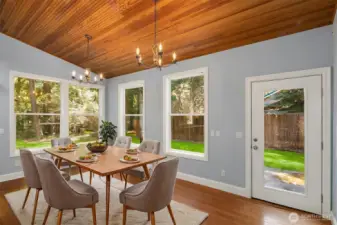 Virtually staged dining room, every window looks out to park like yard