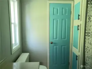 View of the Newer Painted Primary Master Bathroom Showing 3 Door Linen Closet.