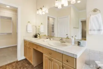 Twin sinks and tiled surfaces on the vanity.