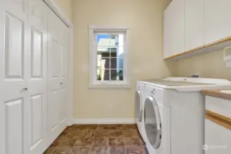 Located just off the kitchen in the hallway to the garage...the laundry room features abundant storage & a deep utility sink.