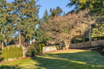 Surrounded by lush, mature landscaping, the property offers privacy, serenity, and partial multi-story views of Lake Washington and the Olympics