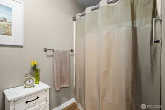 The primary bathroom includes a full tub and shower combo—perfect for a relaxing soak or a quick rinse, whatever the day calls for.
