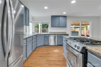 This kitchen layout creates the perfect ergonomic triangle functionality between refrigerator, stove, and under-mount sink.
