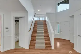 A beautiful, wide staircase leads to the upper level great room.