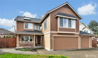 The three-car garage, with custom floor covering, offers ample parking and storage options.