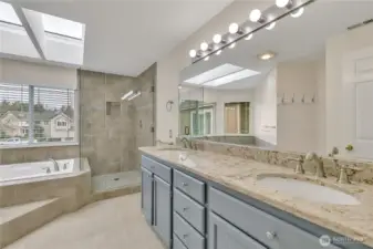 Enjoy a spa-like retreat complete with soaking tub, large, full-glass tiled walk-in shower, and tile floor.