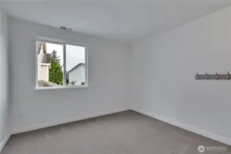 Here is another large bedroom with a big window.