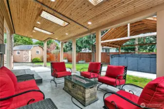 Skylights allow natural light to reach this amazing outdoor living space. The gas fire-pit and furniture convey with the home.