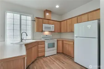 Kitchen is open to the dining area.  Newer fridge.