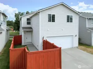 2 cars can fit on the garage cement pad.  Fence recently stained.