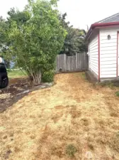 Side of home leading to fenced back yard