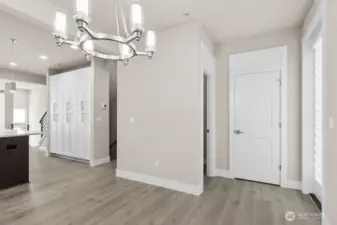 Powder bathroom and closet shown ahead to the right.