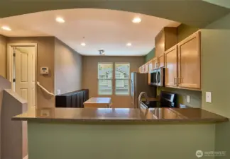 Granite breakfast bar. (half bath door in distance off of stairway).