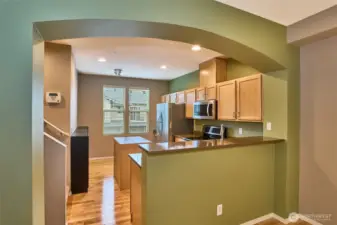 Nice arch kitchen with hardwood floors.