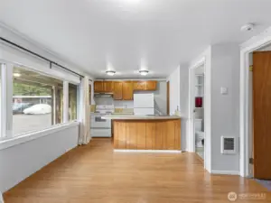 Kitchen, lliving area combo with a bar space for eating.