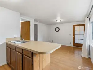Kitchen, lliving area combo with a bar space for eating.