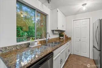 Conveniently located off the dining room, the kitchen features a spacious pantry, granite countertops, and all-new stainless steel appliances.
