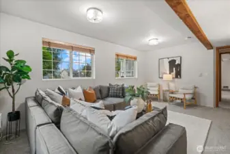 This fourth bedroom/family room features a lovely ceiling beam accent, new, updated lighting, and two large windows that fill the space with abundant natural light for a bright airy feel.