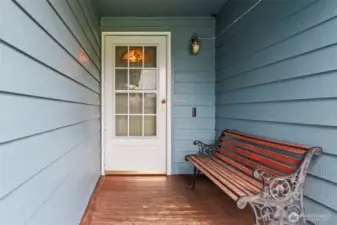 The covered front porch has just enough room for a bench where you can remove your shoes and release your outside concerns.