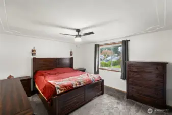 The primary suite is spacious with room for a king bed and several other pieces of furniture.