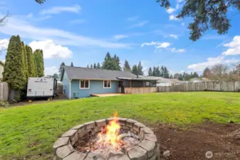 The back portion of the yard includes a fire pit, play area, shed, and the chicken coop.